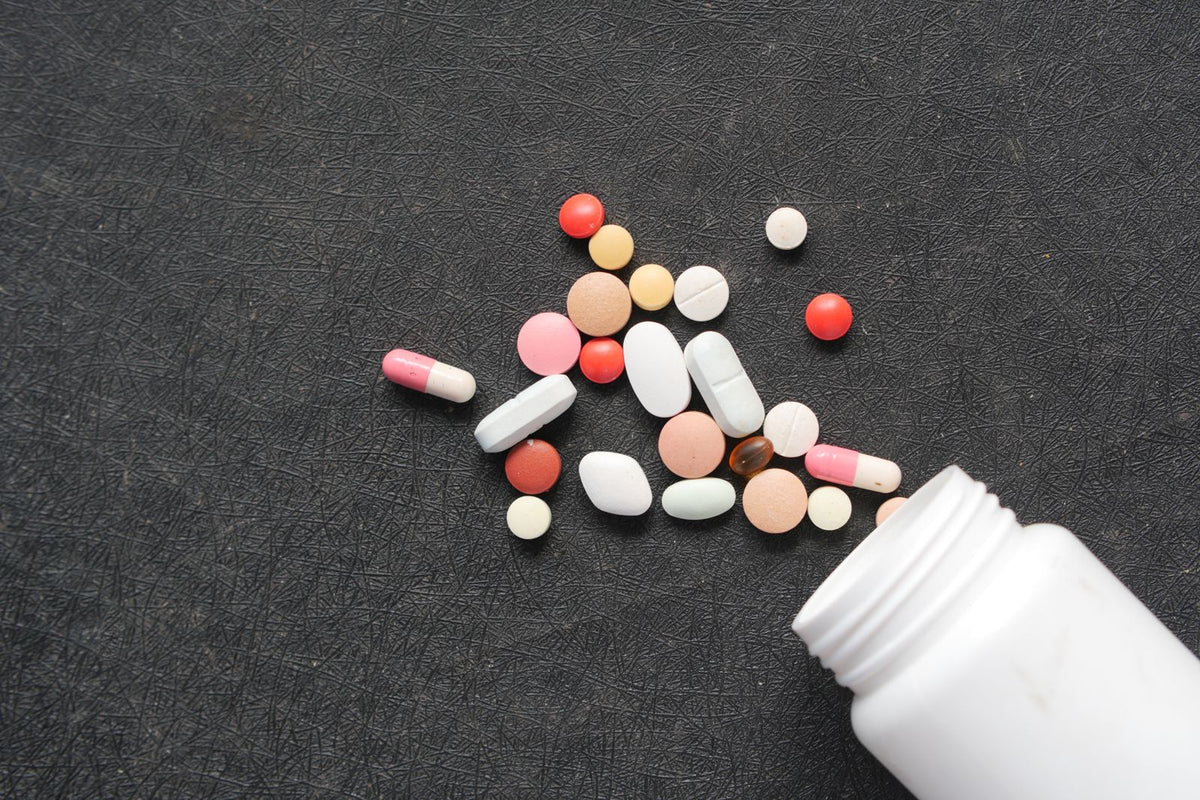 Golden CoQ10 capsules on a dark surface